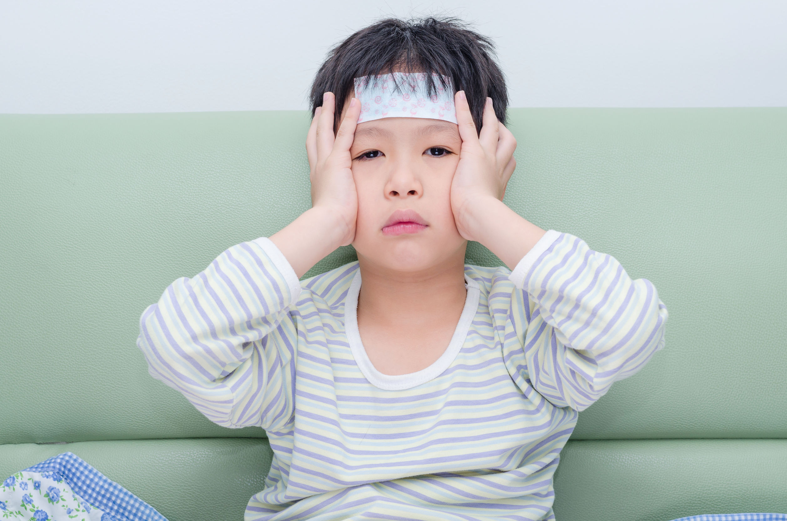 50494097 – little sick boy sitting on sofa